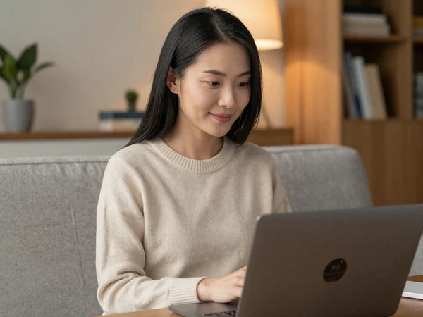 Female doctor smiling during a video call in a modern apartment